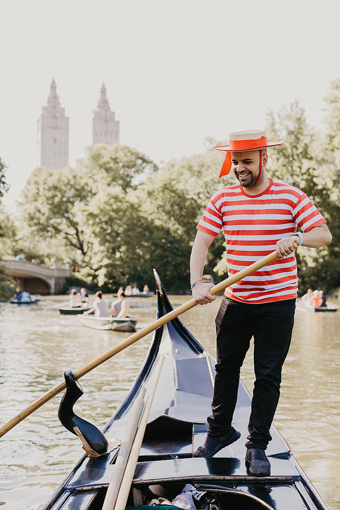 Gondolier and the gondola at the lake in Central Park NYC