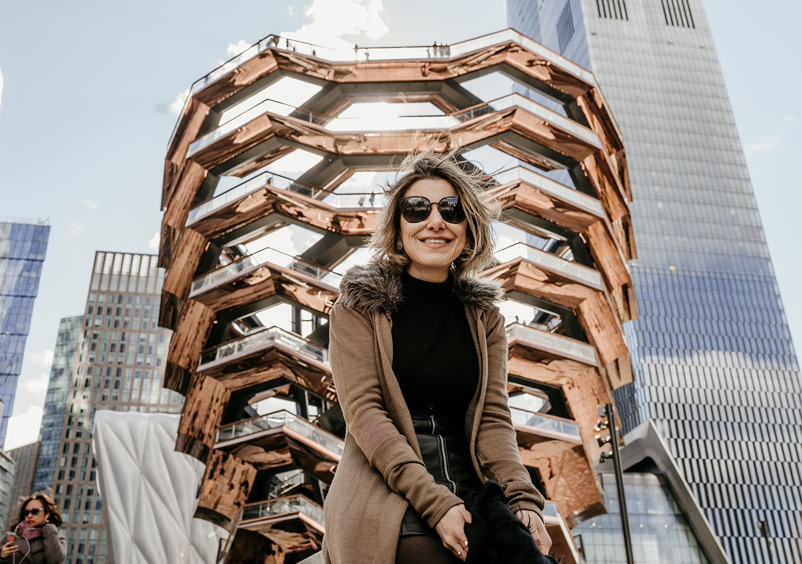 A woman in front of the Vessel at Hudson Yards in NYC